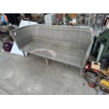 A LARGE WICKER THREE SEATER BENCH