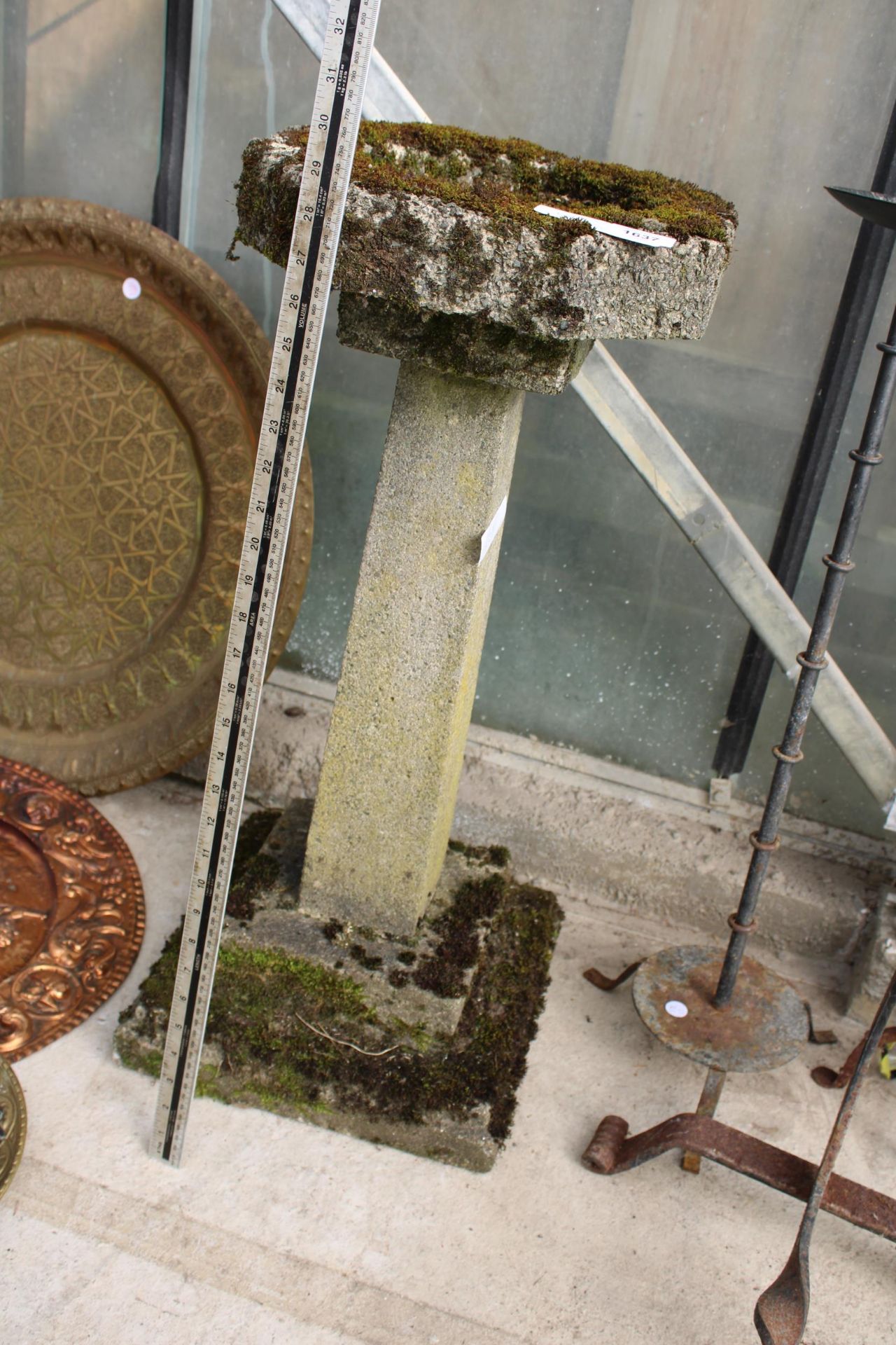 A CONCRETE BIRDBATH WITH PEDESTAL BASE