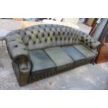 A GREEN LEATHER CHESTERFIELD FOUR SEATER SETTEE