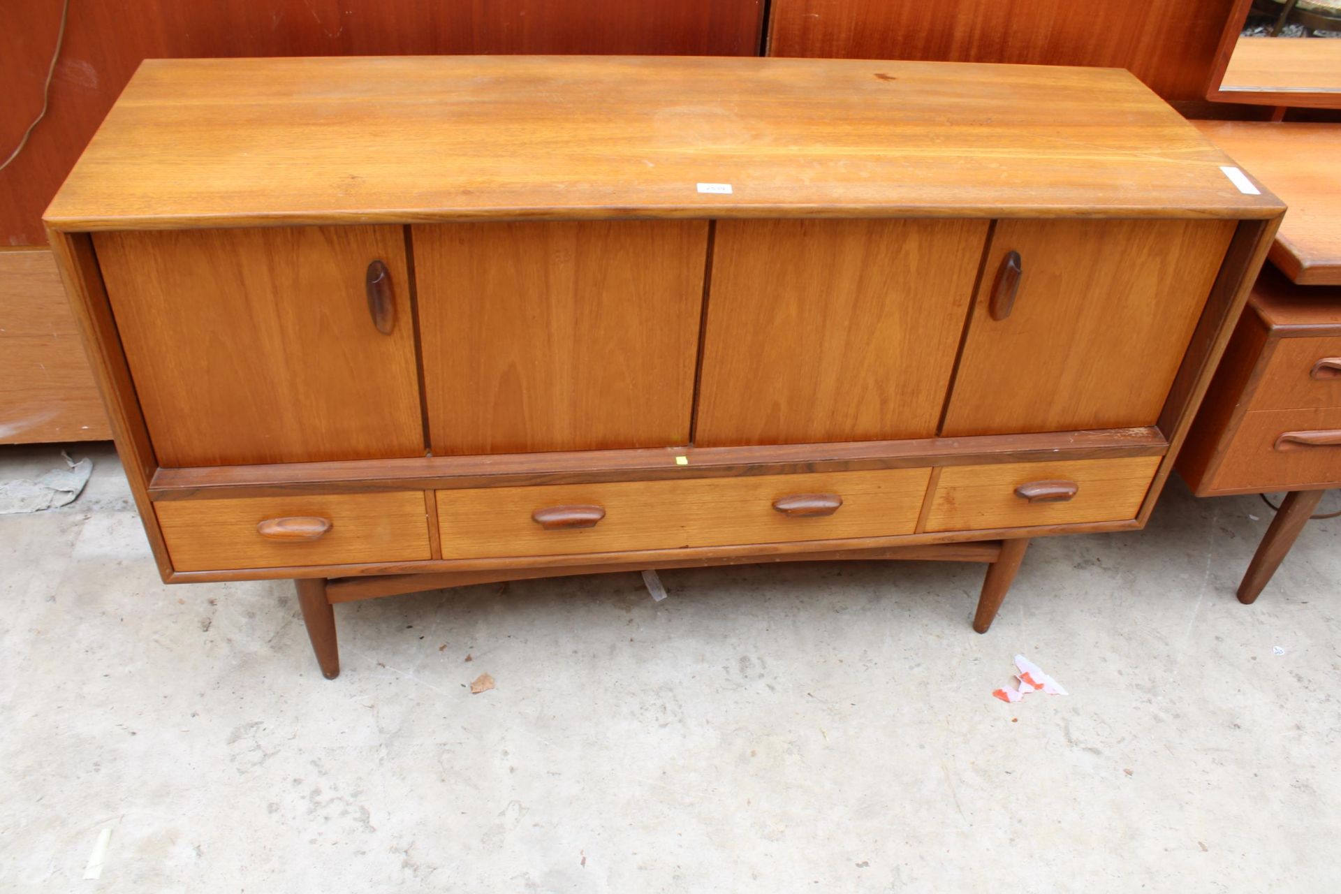 A G PLAN RETRO TEAK SIDEBOARD ENCLOSING TWO BI FOLD DOORS AND THREE DRAWERS 57" WIDE