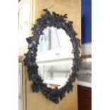 A VICTORIAN STYLE CAST IRON WALL MIRROR WITH VINE LEAF DECORATION, 19" X 14"