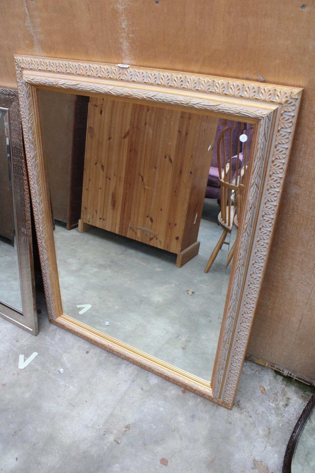 A GILT EFFECT BEVEL EDGE WALL MIRROR 48" X 37"