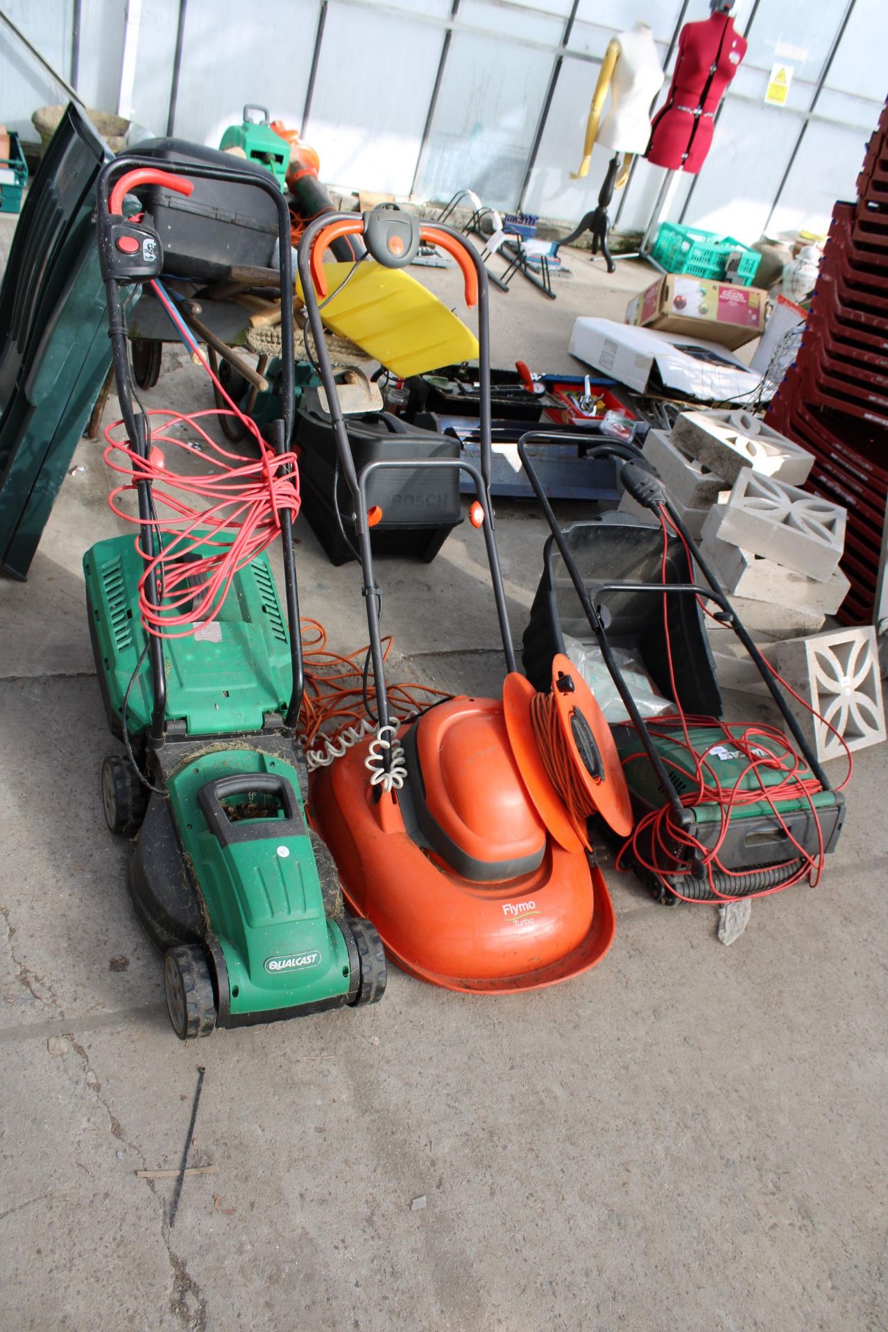 AN ELECTRIC FLYMO, AN ELECTRIC QUALCAST LAWN MOER AND A QUALCAST ELECTRIC LAWN RAKE