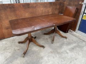 A MAHOGANY TWIN PEDESTAL DINING TABLE WITH THREE EXTRA LEAVES