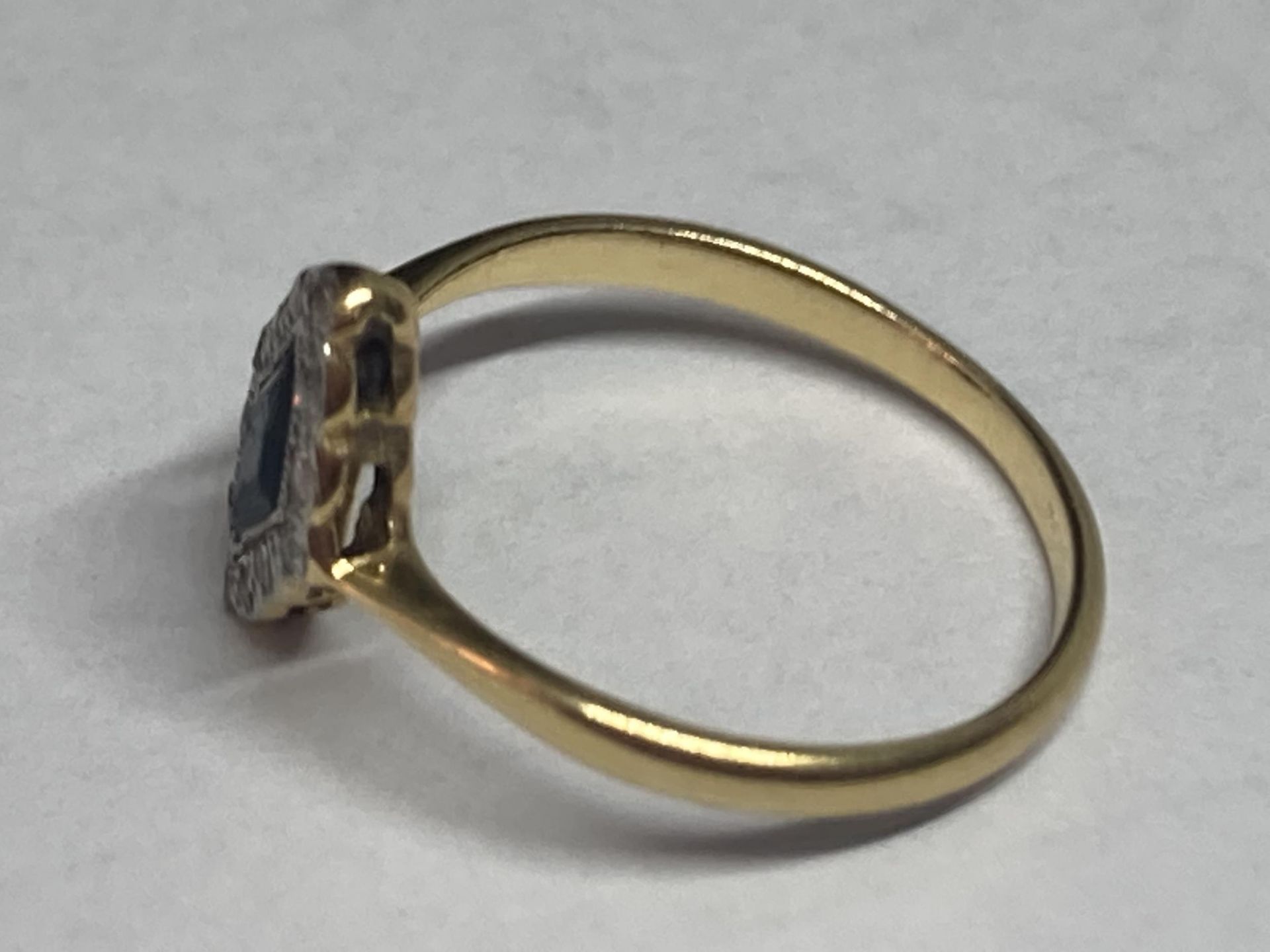 A 9 CARAT GOLD RING WITH A DIAMOND SHAPED SAPPHIRE SURROUNDED BY DIAMONDS SIZE J/K - Image 2 of 3