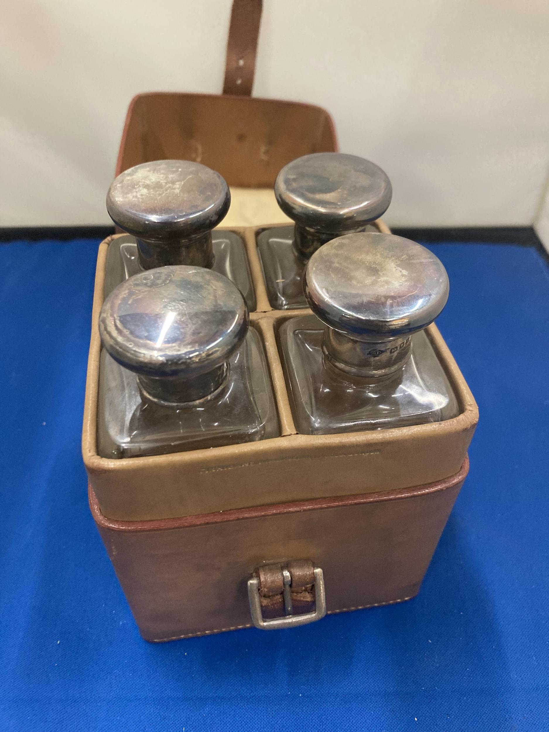 A VINTAGE LEATHER CASE CONTAINING FOUR GLASS BOTTLES WITH HALLMARKED SILVER TOPS - Image 3 of 6