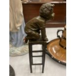 A SIGNED BRONZE CHILD ON A CHAIR, HEIGHT 24CM
