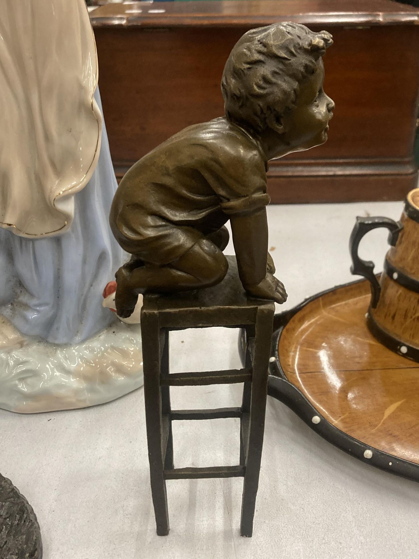 A SIGNED BRONZE CHILD ON A CHAIR, HEIGHT 24CM