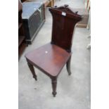 A VICTORIAN MAHOGANY HALL CHAIR ON TURNED FRONT LEGS