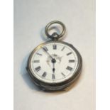 A MARKED 800 SILVER POCKET WATCH WITH WHITE ENAMEL DECORATIVE FACE AND ROMAN NUMERALS