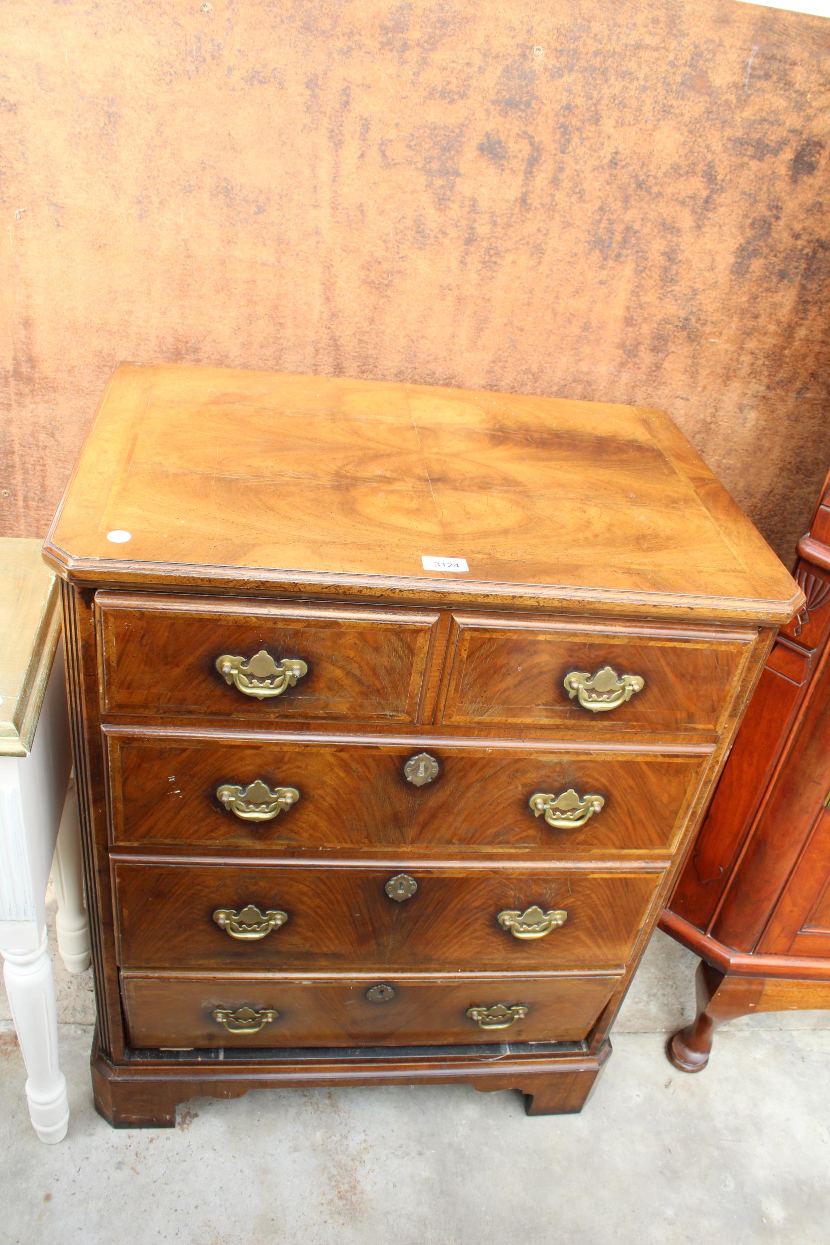 AN ANTIQUE STYLE WALNUT AND CROSS BANDED UNIT IN THE FORM OF A CHEST OF DRAWERS, 27" WIDE