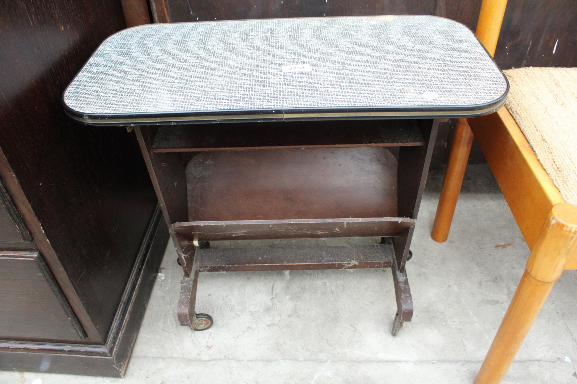 A RETRO FORMICA TOP MAGAZINE RACK/TABLE