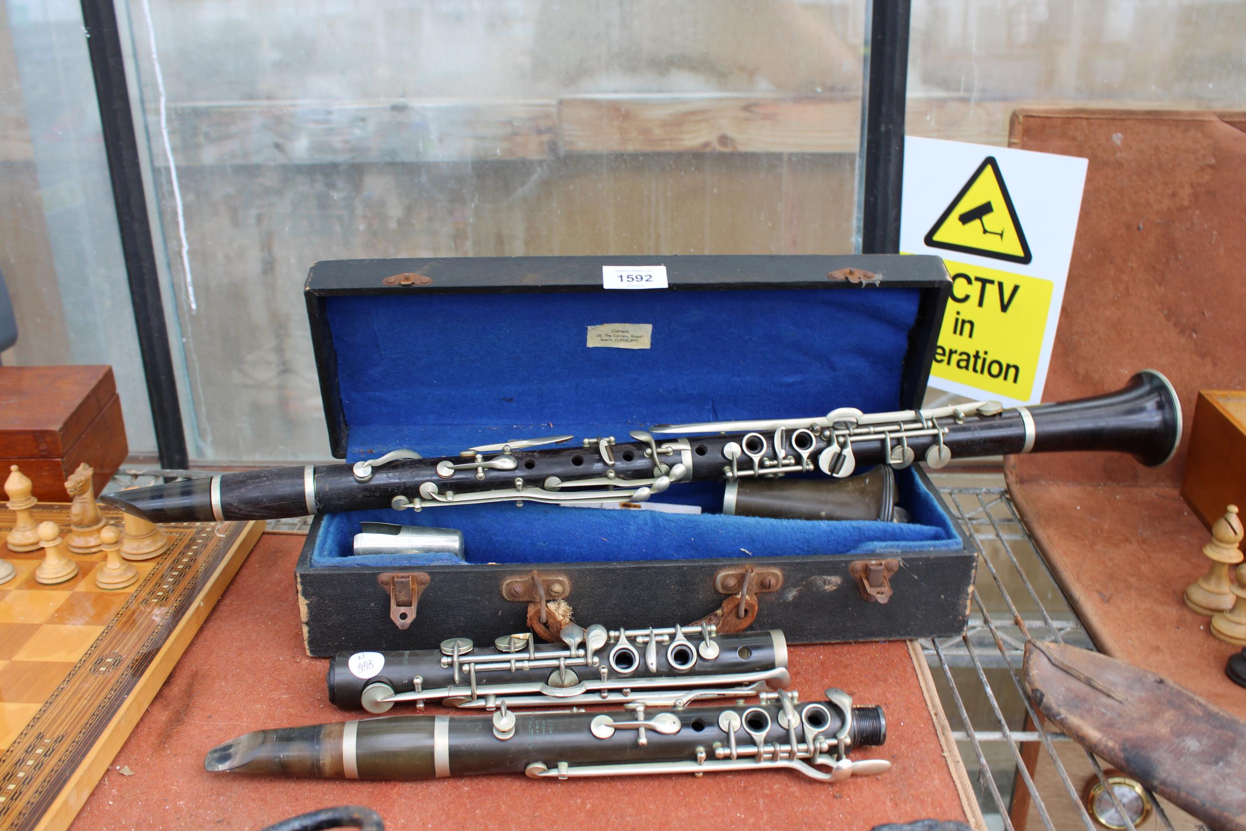 A BELIEVED COMPLETE VINTAGE JACQUES ALBERT CLARINET WITH CARRY CASE AND AN ASSORTMENT OF BOOZY