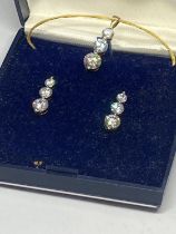 A SILVER CUBIC ZIRCONIA PENDANT AND EARRING SET IN A PRESENTATION BOX