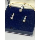 A SILVER CUBIC ZIRCONIA PENDANT AND EARRING SET IN A PRESENTATION BOX
