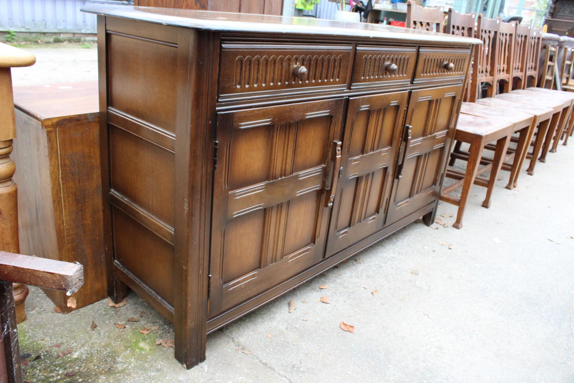 A REPRODUCTION DRESSER BASE ENCLOSING THREE DRAWERS AND THREE CUPBOARDS, 60" WIDE - Image 2 of 3