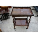 AN EARLY 20TH CENTURY OAK FOLD OVER GAMES TABLE/TROLLEY ON TURNED LEGS 24" WIDE