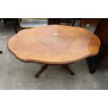 AN OVAL ITALIAN STYLE COFFEE TABLE ON A PEDESTAL BASE