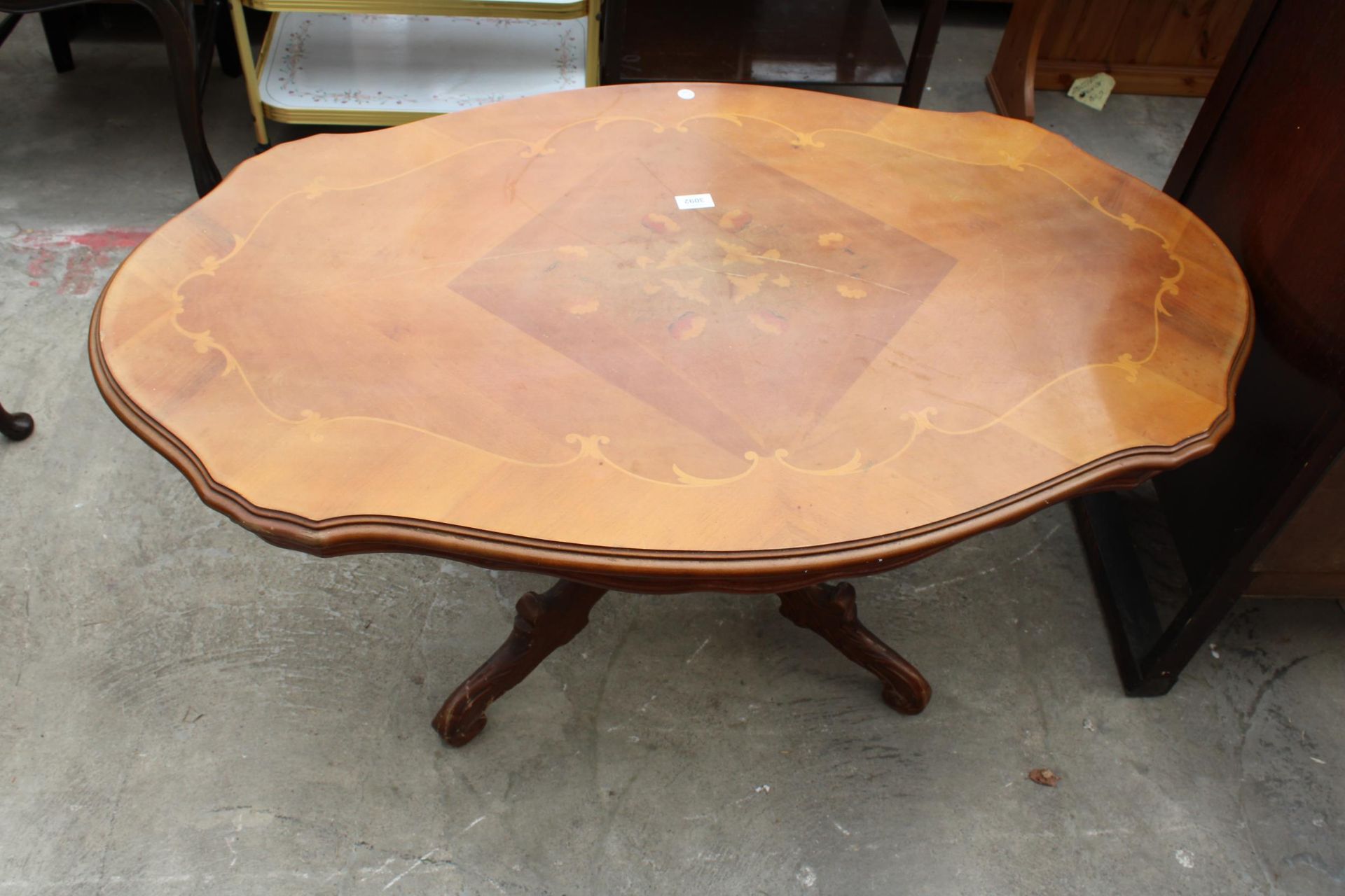 AN OVAL ITALIAN STYLE COFFEE TABLE ON A PEDESTAL BASE