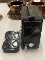 A VINTAGE BAKELITE DEKKO CINE CAMERA AND FILM