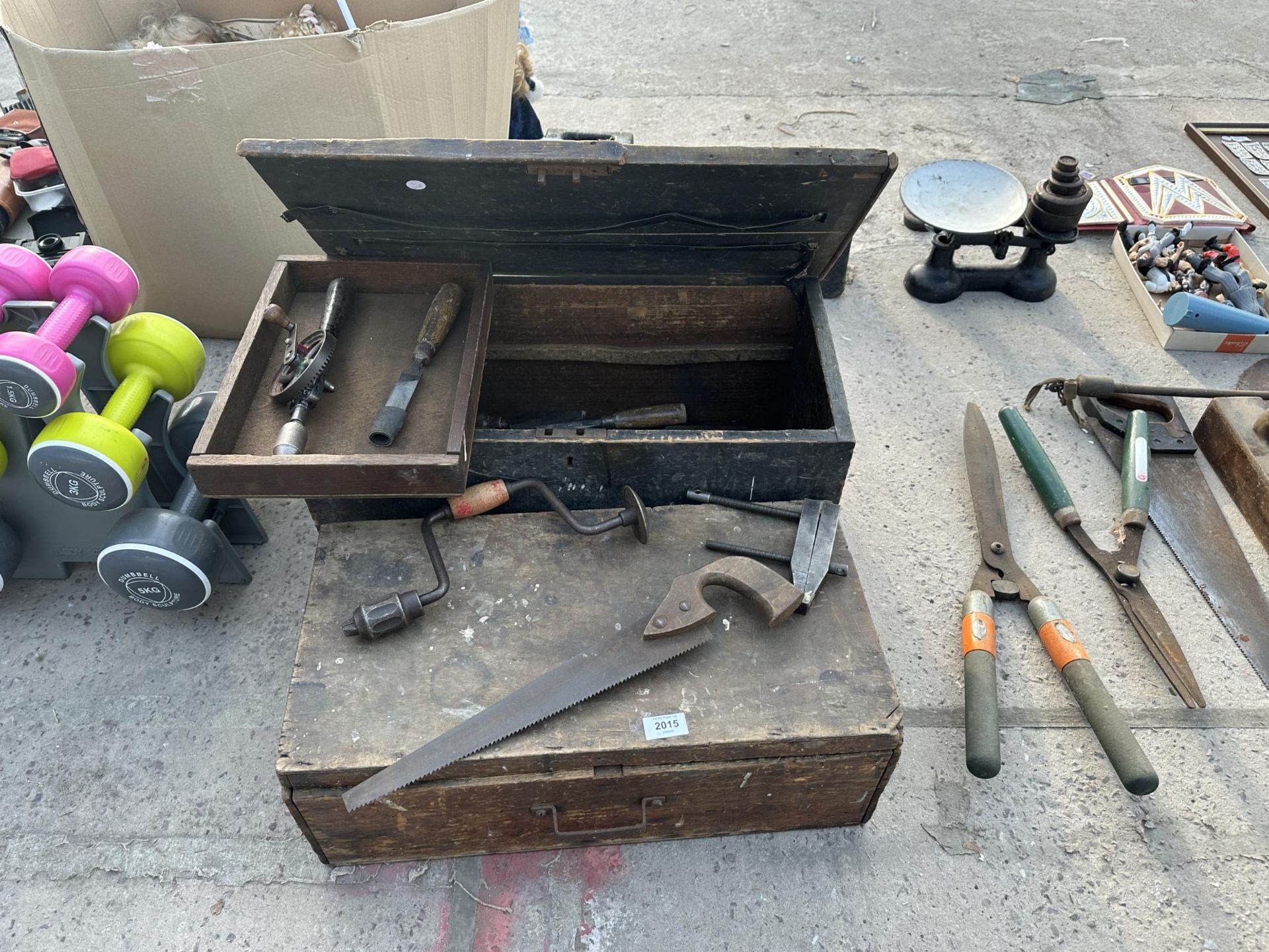 TWO VINTAGE WOODEN TOOL CHESTS WITH AN ASSORTMENT OF TOOLS TO INCLUDE CLAMPS, CHISELS AND BRACE