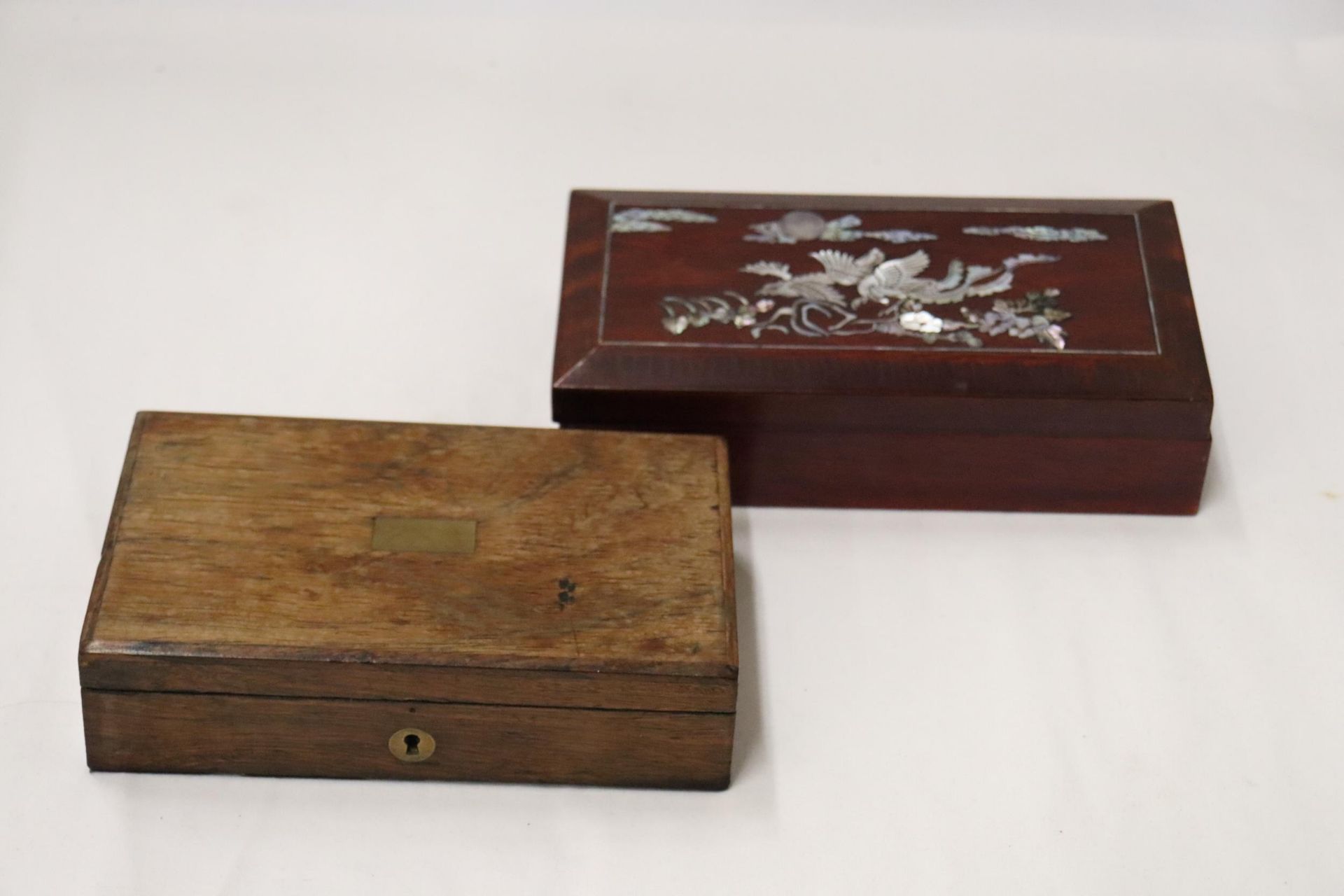 A VINTAGE OAK BOX WITH BRASS ESCUTCHEON, PLUS AN ORIENTAL STYLE WITH MOTHER OF PEARL DECORATION