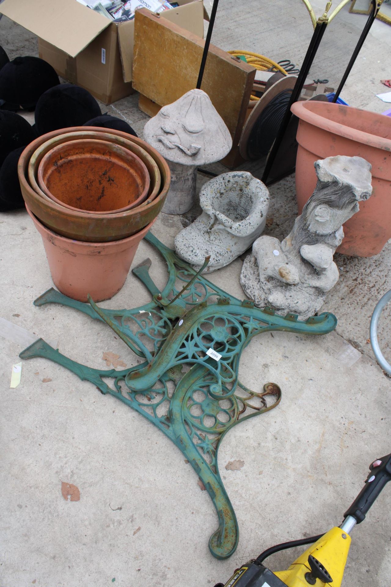 AN ASSORTMENT OF GARDEN ITEMS TO INCLUDE CAST BENCH ENDS, TERRACOTTA POTS AND CONCRETE FIGURES ETC