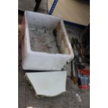 A WHITE BELFAST SINK AND A DECORATIVE WOODEN WALL SHELF