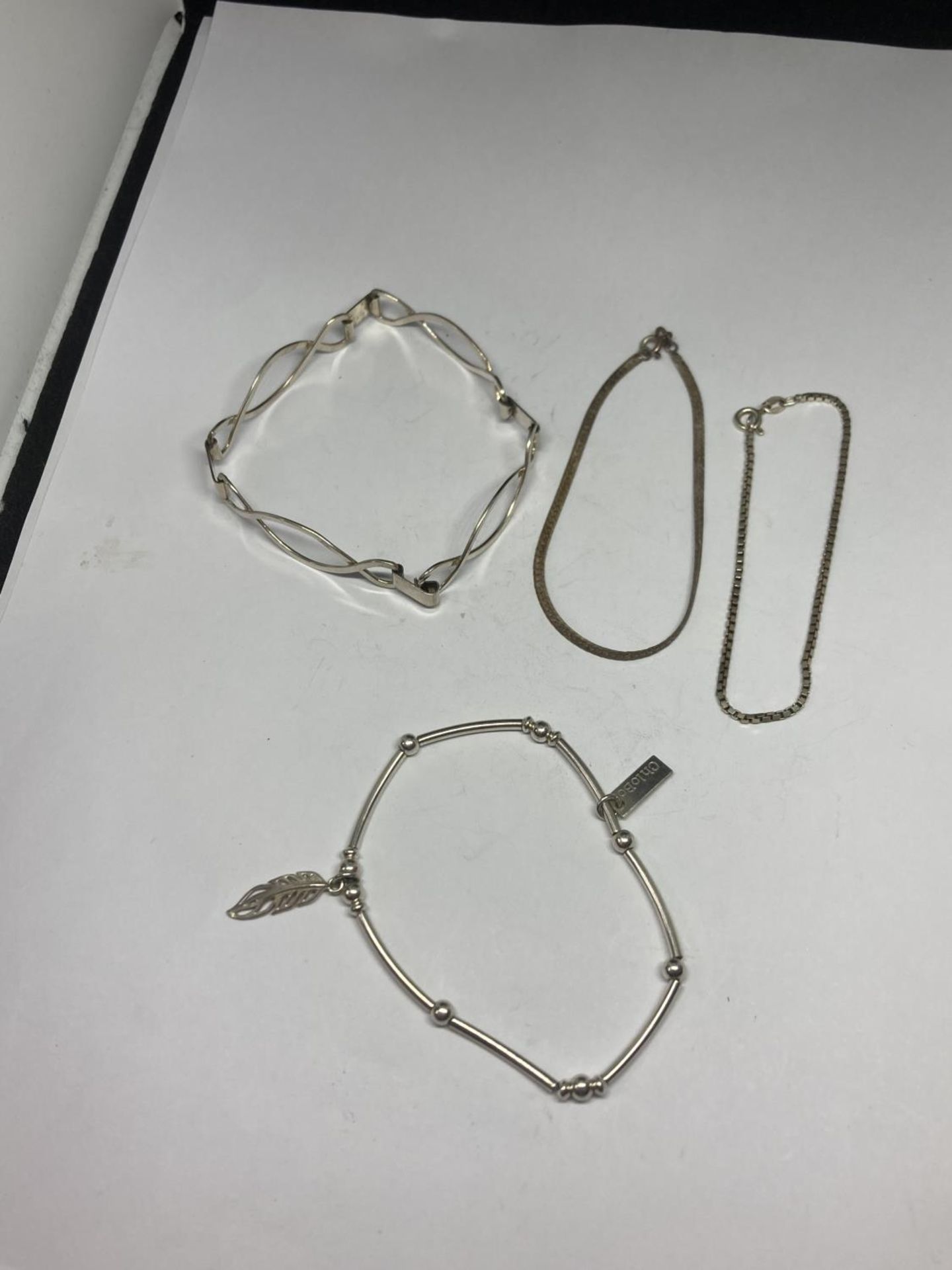 FOUR SILVER BRACELETS