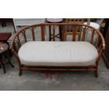 A BAMBOO AND WICKER TWO SEATER SETTEE