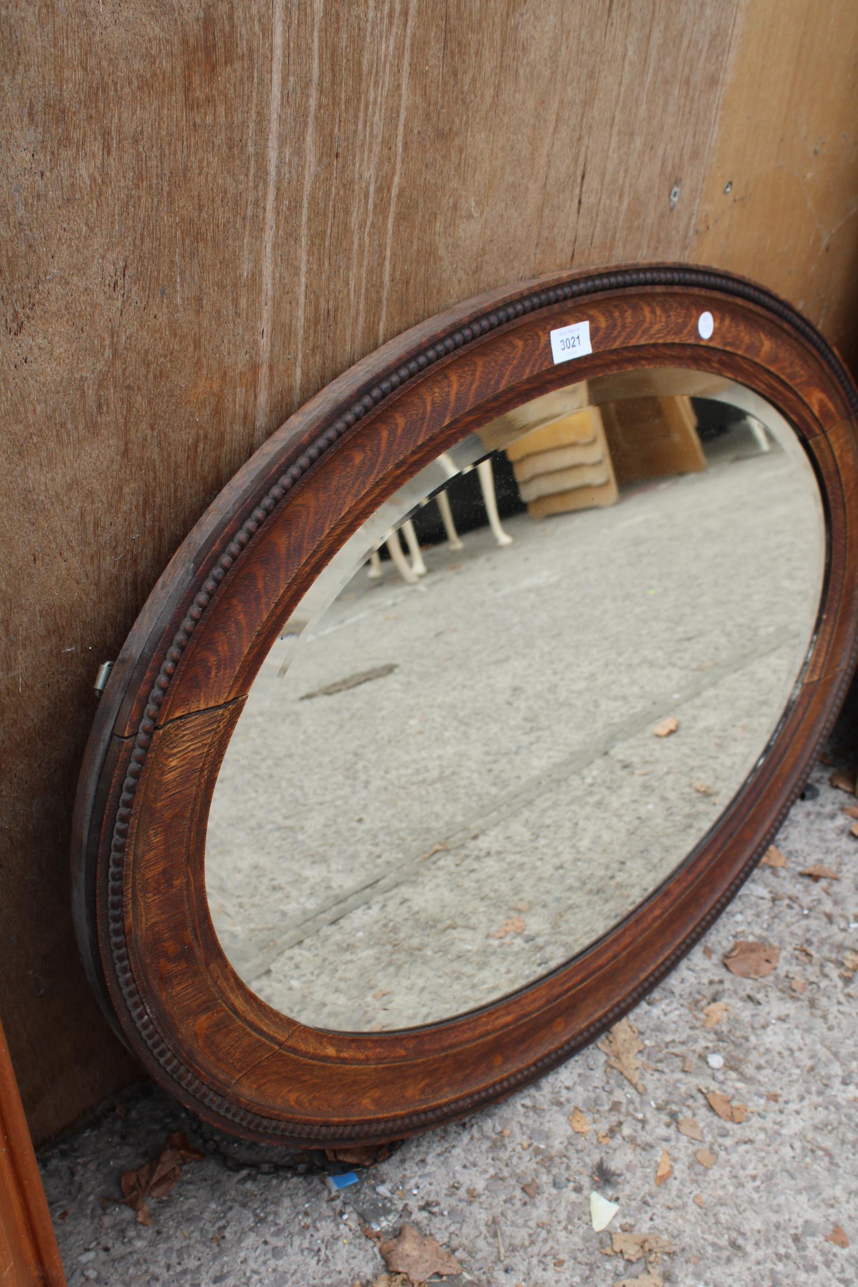 A MID 20TH CENTURY OVAL OAK BEVEL EDGED MIRROR 34" X 24" - Image 2 of 3