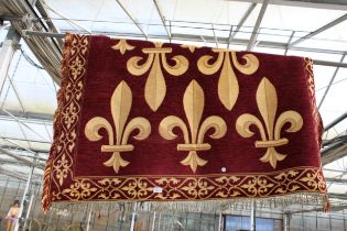 A RED PATTERNED FRINGED RUG