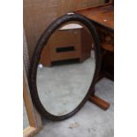 AN EDWARDIAN OVAL BEVEL EDGE MIRROR 33" X 22"