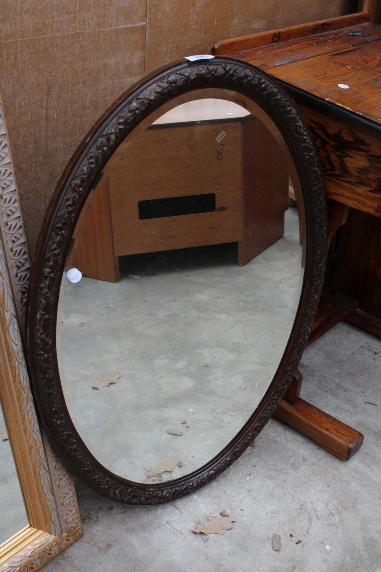 AN EDWARDIAN OVAL BEVEL EDGE MIRROR 33" X 22"