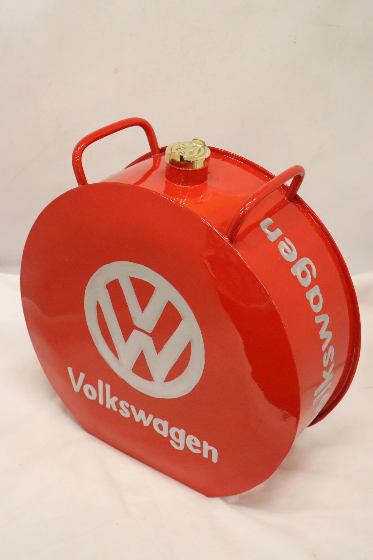 A LARGE RED VOLKSWAGON PETRO CAN