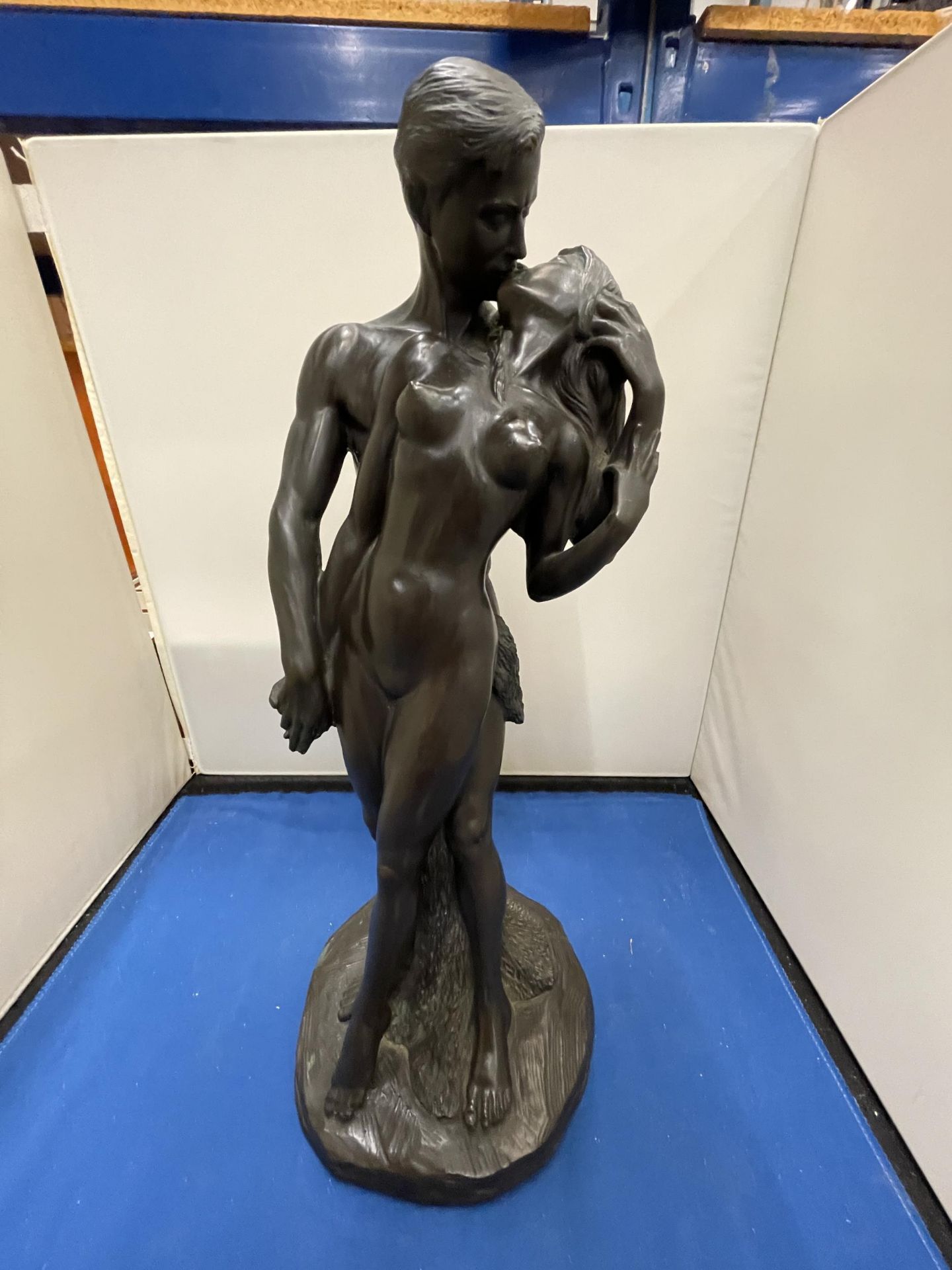 A BRONZED FIGURE OF MALE AND FEMALE NUDES SIGNED