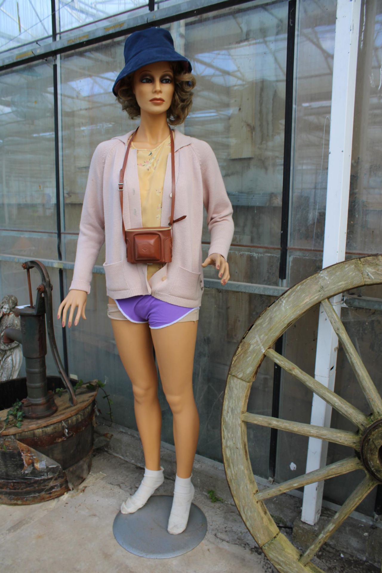 A FEMALE SHOP DISPLAY MANNEQUIN WITH STAND AND CLOTHING