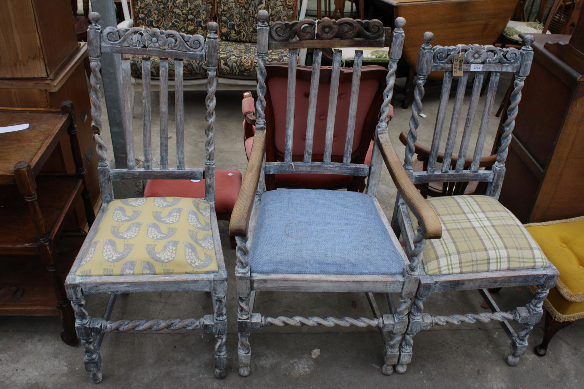THREE EARLY 20TH CENTURY LIMEDOAK DINING CHAIRS, ONE BEING A CARVER ON BARLEY TWIST LEGS AND