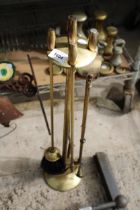 A VINTAGE BRASS COMPANION SET