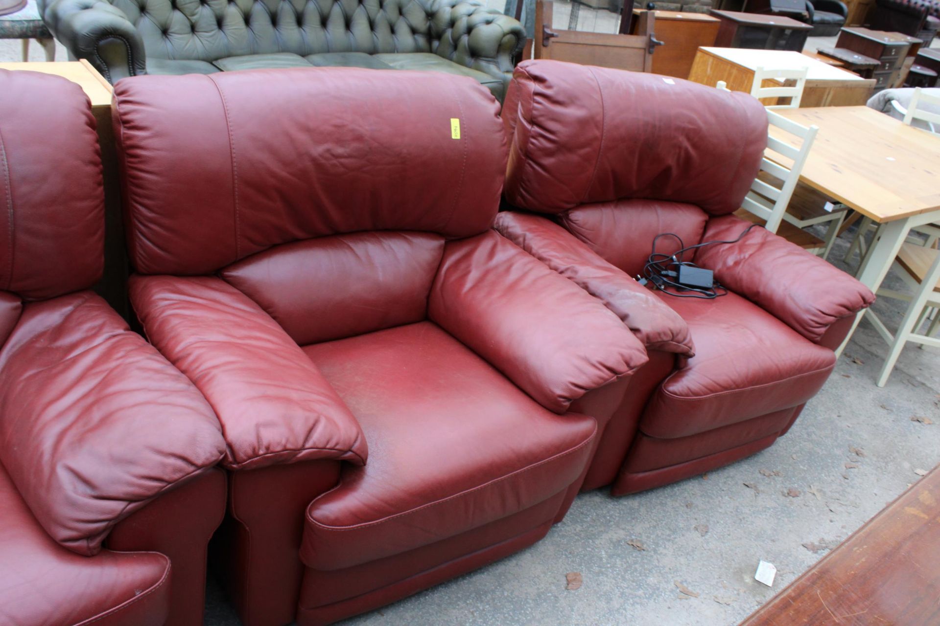 A RED LEATHER VIOLINO THREE PIECE SUITE COMPRISING OF A THREE SEATER SETTEE, EASY CHAIR AND AN - Image 2 of 3