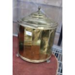 A VINTAGE BRASS LIDDED COAL BUCKET WITH LION PAW FEET