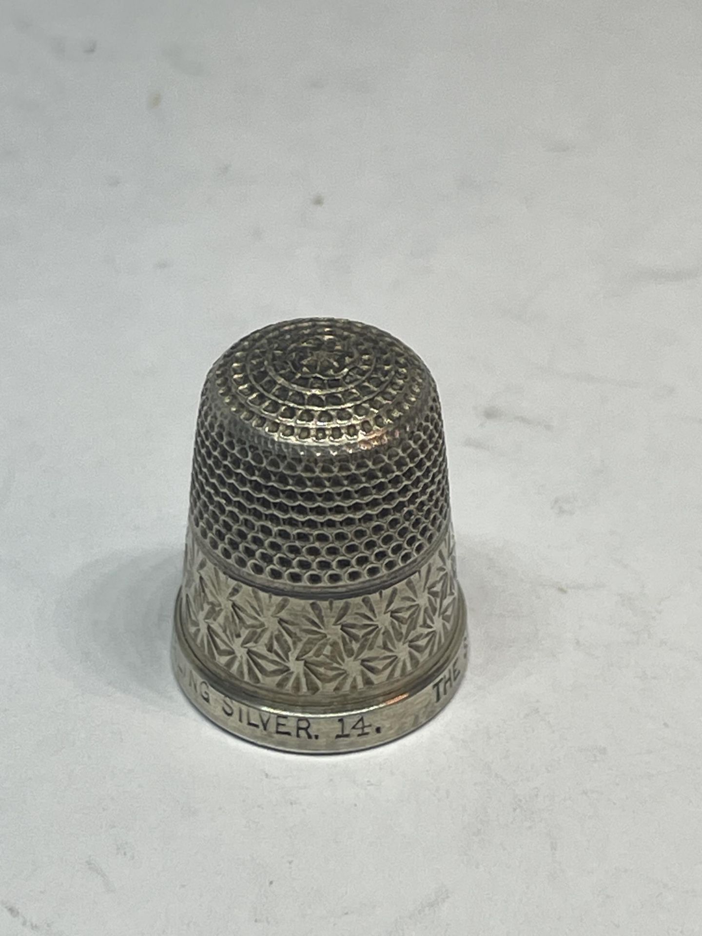 A MARKED STERLING SILVER THE SPA THIMBLE
