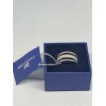 A SWAROVSKI CRYSTAL RING SIZE Q/R WITH LABEL AND PRESENTATION BOX