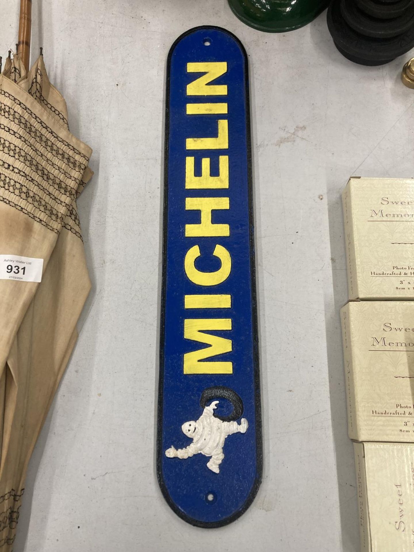 A CAST BLUE AND YELLOW MICHELIN SIGN