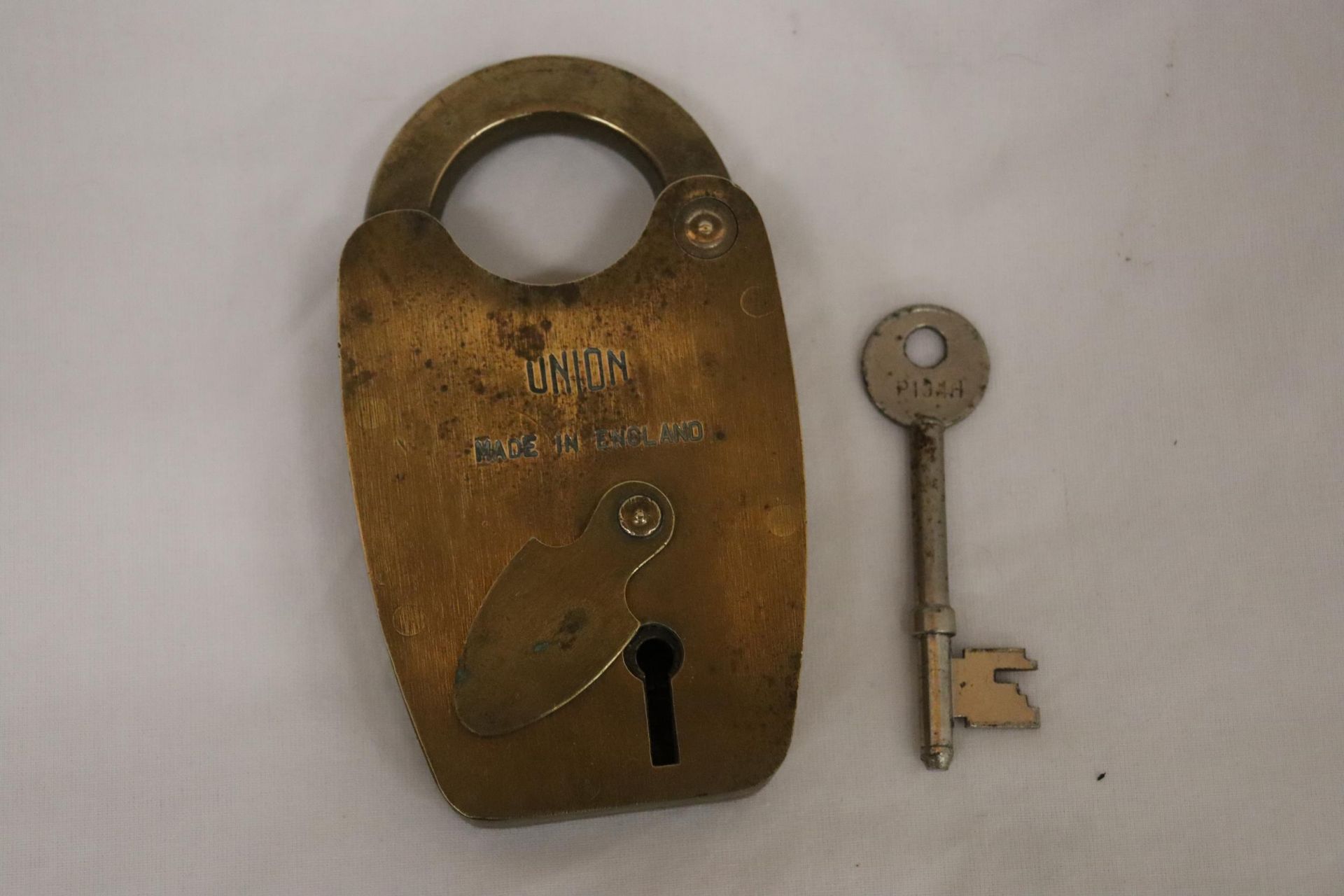 A VINTAGE BRASS UNION PADDLOCK AND KEY - 5 INCH TALL