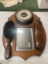 A VINTAGE OAK HALL MIRROR WITH BAROMETER AND BRUSH