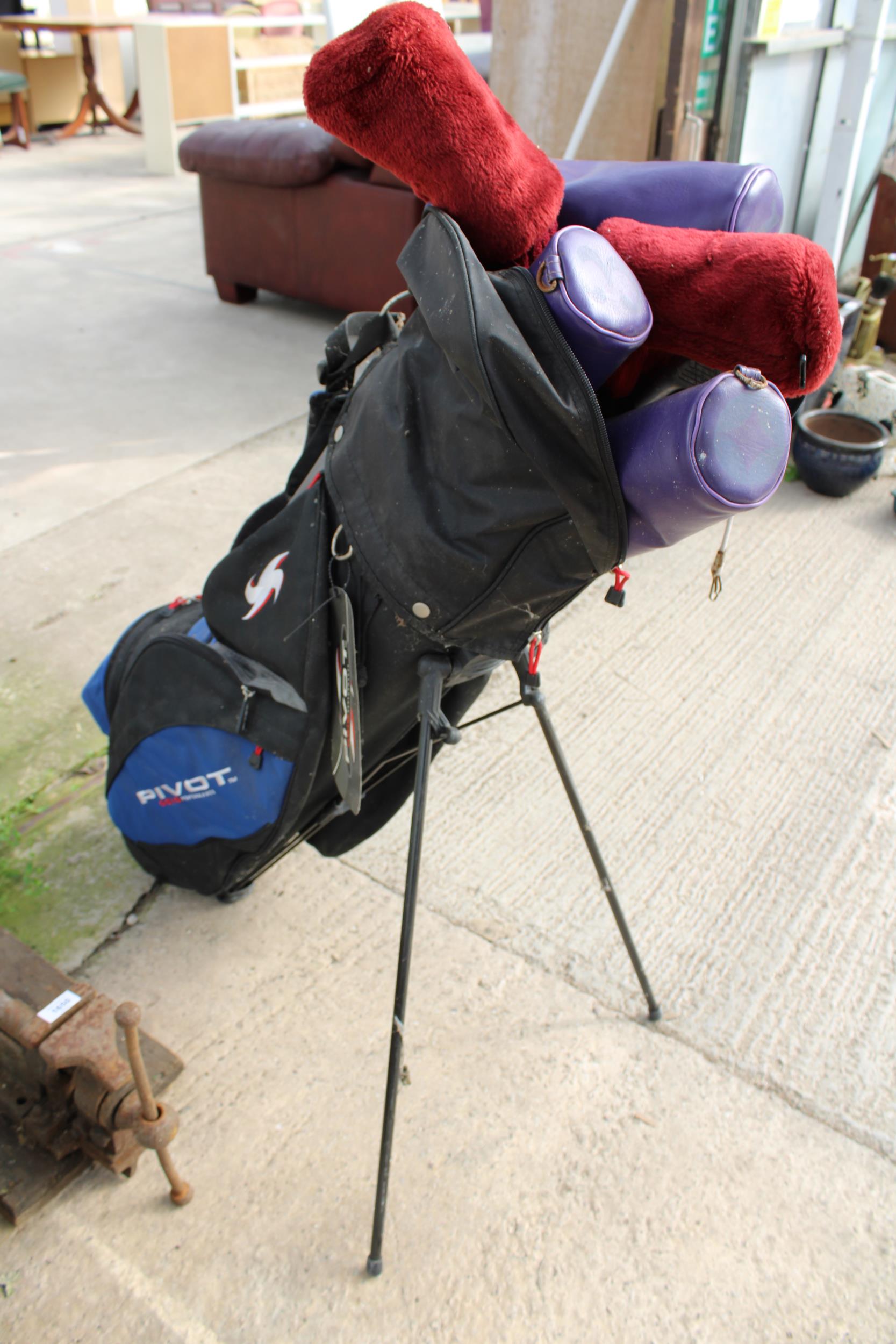 A PIVOT GOLF BAG AND AN ASSORTMENT OF GOLF CLUBS