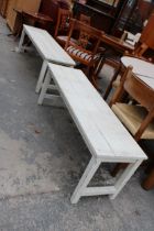 A PAIR OF WHITE PAINTED BENCH/TABLES 56" X 15" AND 52" X 15"