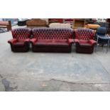 A LEATHER OXBLOOD CHESTERFIELD THREE PIECE SUITE