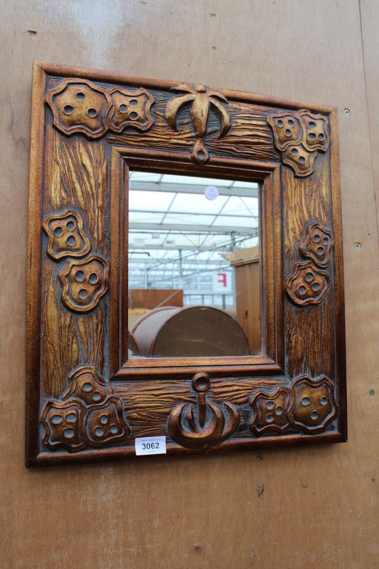 A BRONZE EFFECT WALL MIRROR 19" X 17"